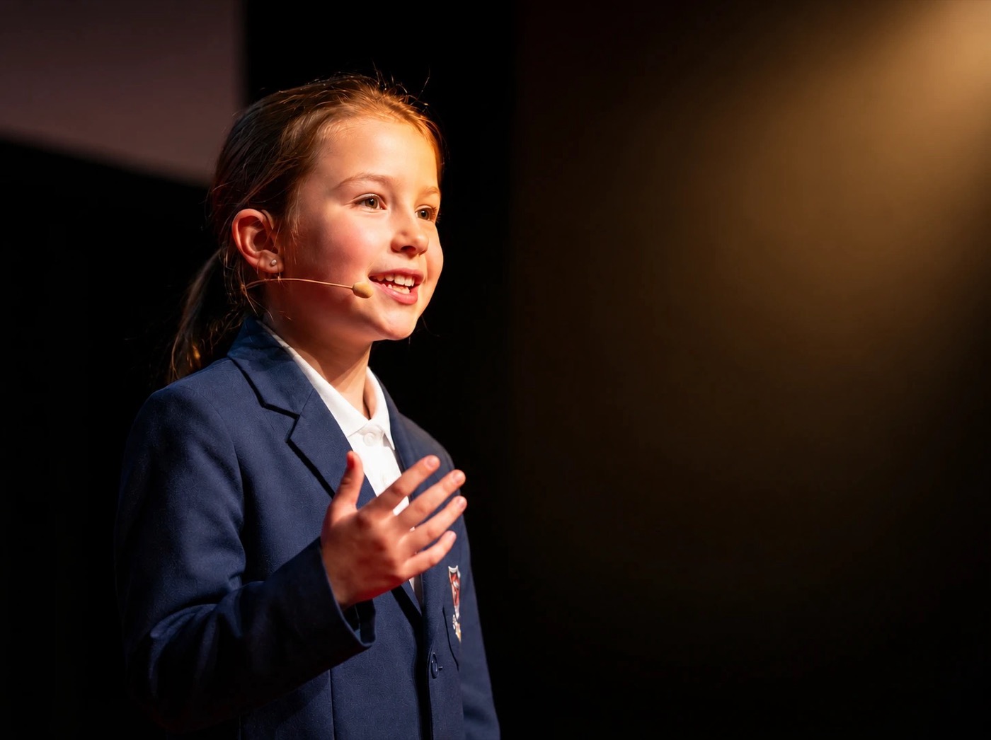 A student giving a speech on stage